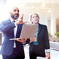 Two business professionals discussing project details.