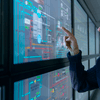 Person pointing at digital data screen.