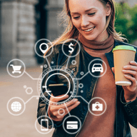 girl looking through her phone while a cup of coffee