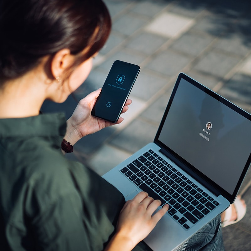 Woman working on laptop at desk, logging into computer