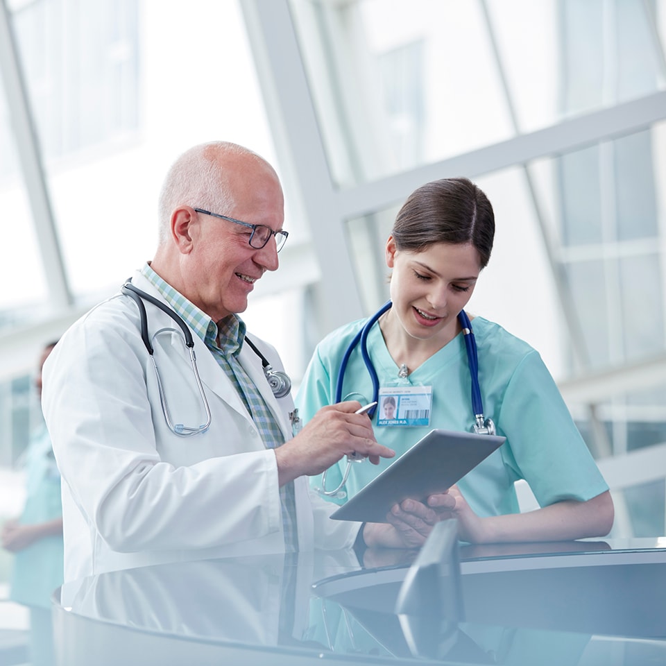 Doctors sharing content on digital tablet 