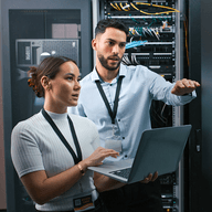 Two colleagues working in the server room