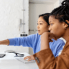 two girls working together