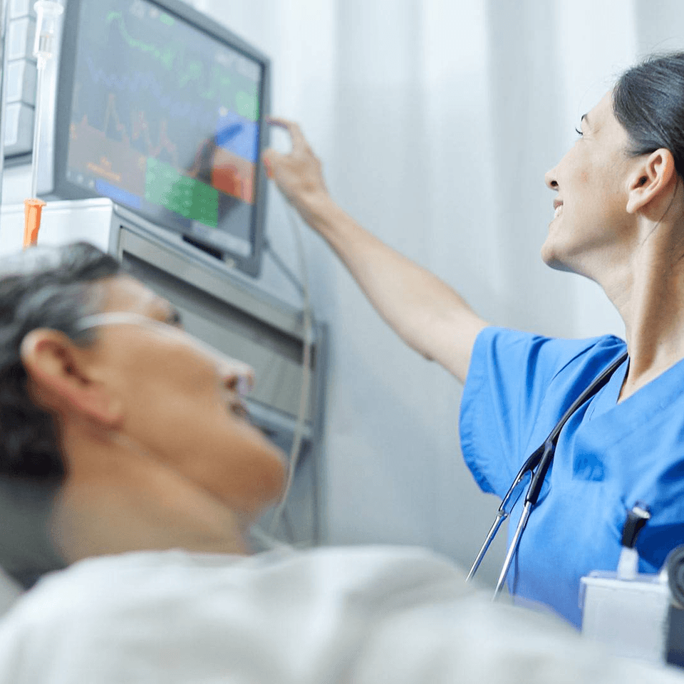 A nurse checking on her patient
