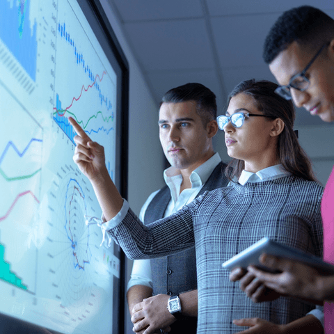 business team viewing charts and graphs on interactive-screen