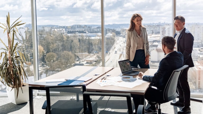 a group of people having a meeting in a room