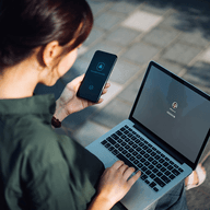 girl using her phone and laptop