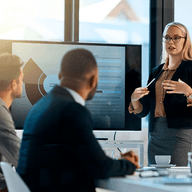 Three business professionals reviewing presentation data.