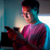 Man using smartphone under neon light
