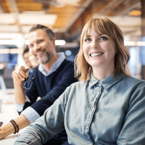Smiling colleagues in modern office.