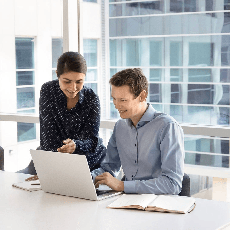 Two people looking at a laptop