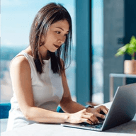 A woman typing on her laptop