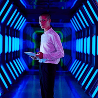 A man in futuristic room with blue lighting