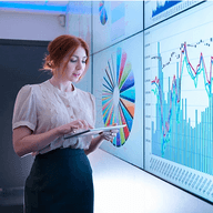 A woman analysing charts of data