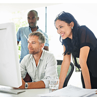 Three peope looking at a monitor