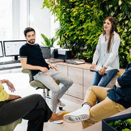 Four people having a conversation in the office