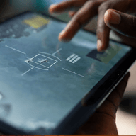 A hand touching a tablet