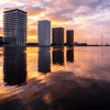 City buildings reflecting on water.