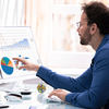 Man pointing at colorful data charts.