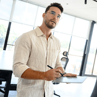 Man writing on tablet in office.