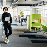 Man standing in modern open office.