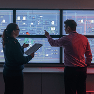 colleagues discussing info on monitors card