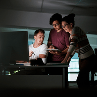 three people working together