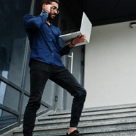 A man holding his laptop