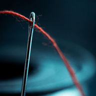 A needle with a red string