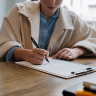A woman writing on a paper
