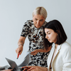 An old woman mentoring a young lady