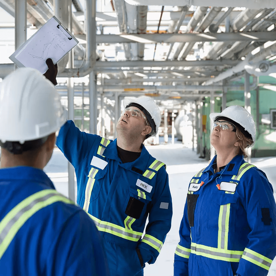 Three engineers looking up