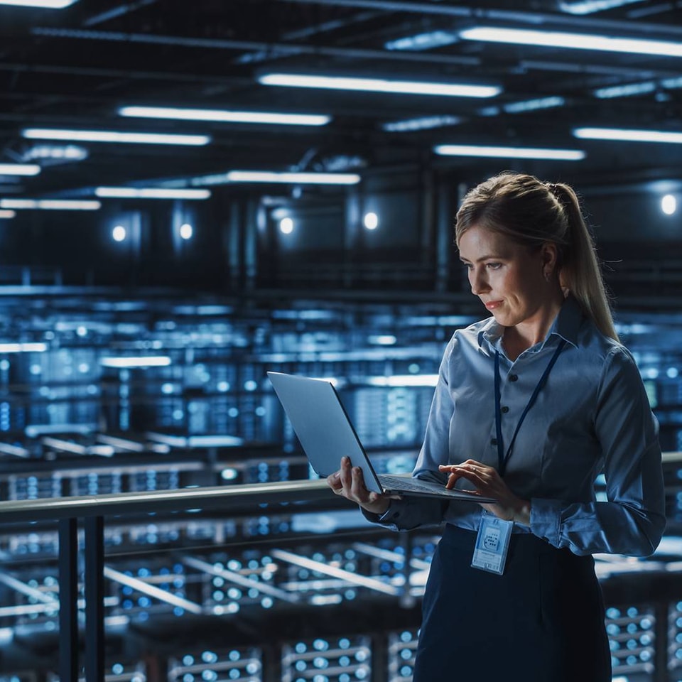 woman using her work computer in the server room