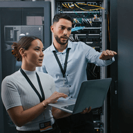 two people working together in a server room