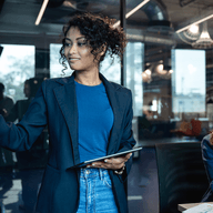 woman presenting to a team in a modern office