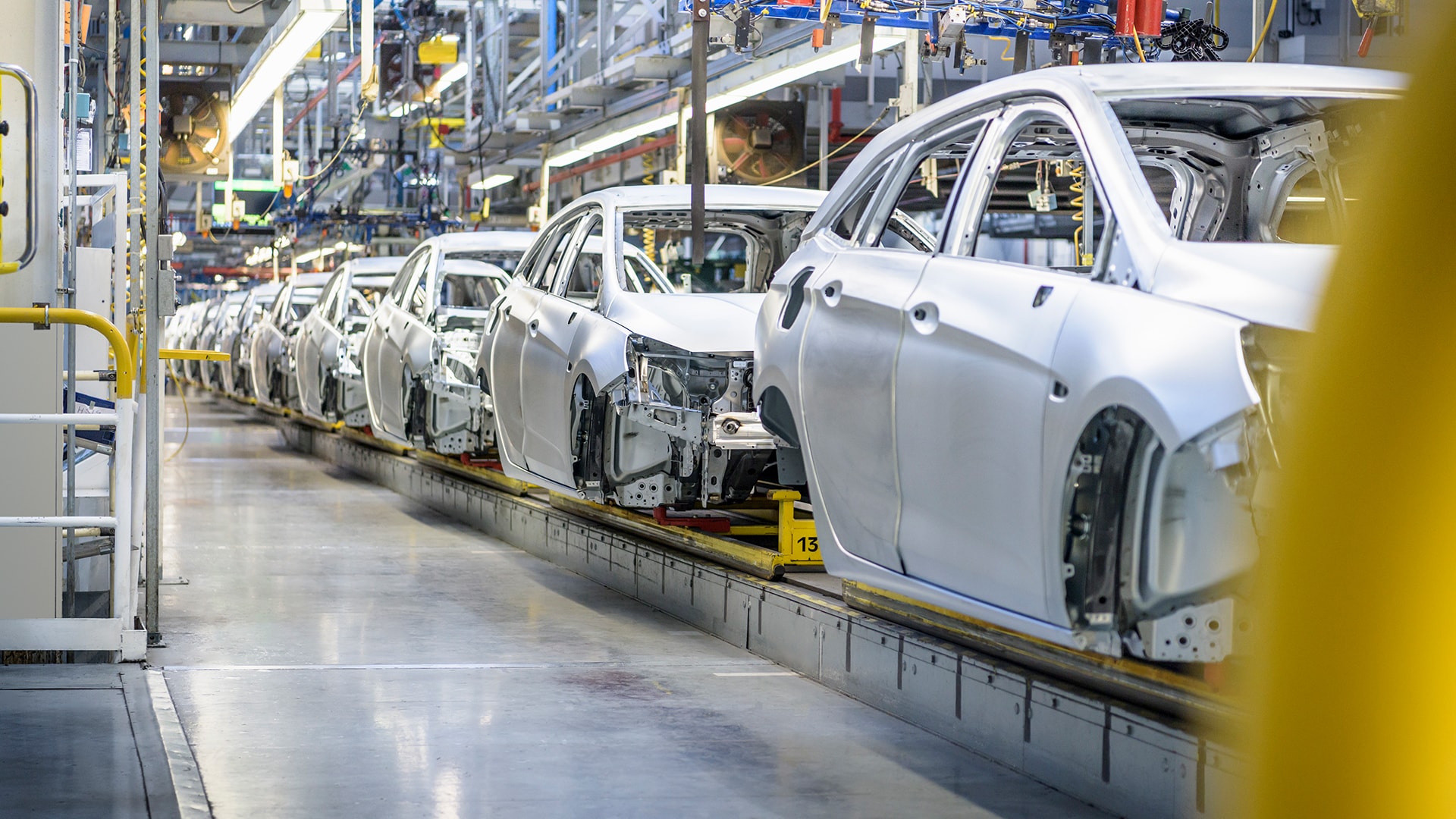 view of cars on production line in factory banner