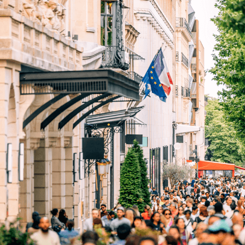 crowds of people shopping on champs elysees avenue