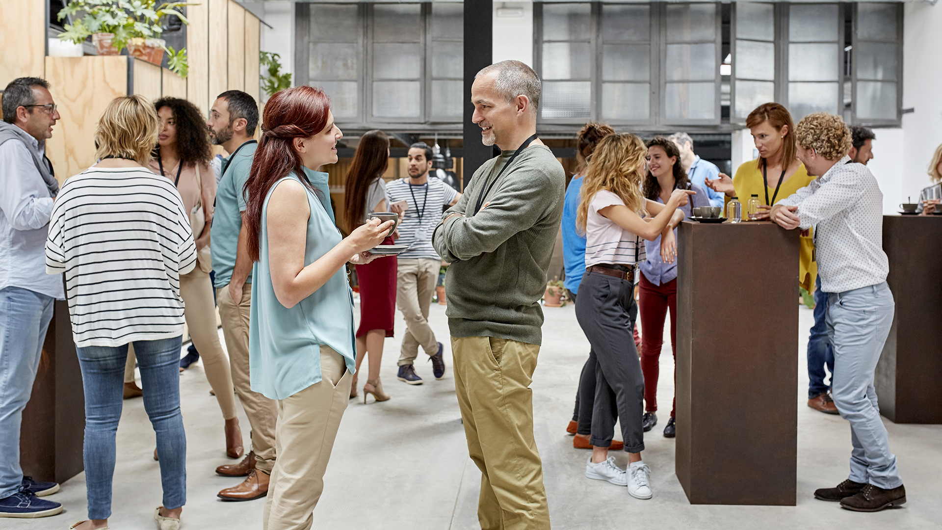 multiple people talking on an exhibition/event floor